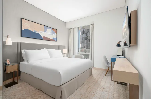 Hotel bed by a window in daylight